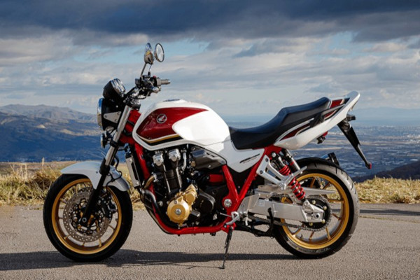 Красный с белым классический дорожный  мотоцикл стоит на видовой площадке.